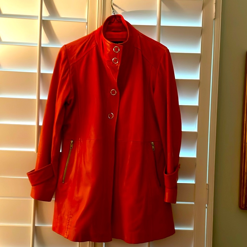 Beautiful dark orange 3/4 length leather coat.  In excellent condition.